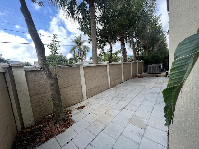 view of patio featuring a fenced backyard and central air condition unit