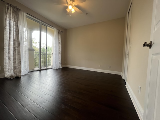 empty room with a ceiling fan, baseboards, and dark wood-style flooring