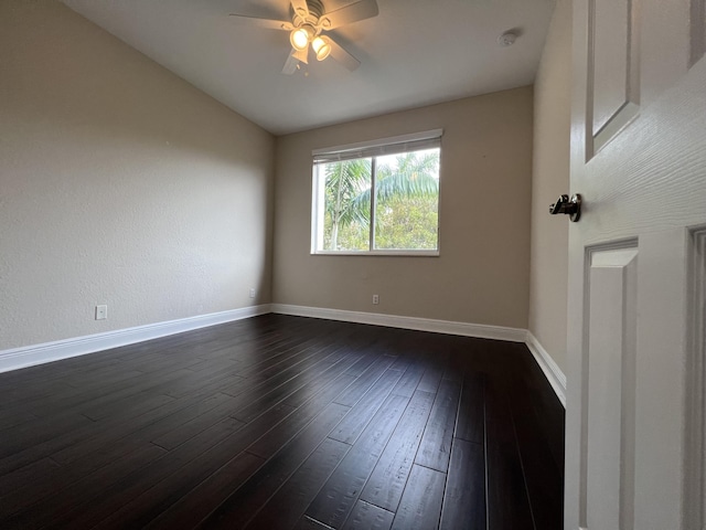 unfurnished room featuring a ceiling fan, lofted ceiling, dark wood-style flooring, and baseboards