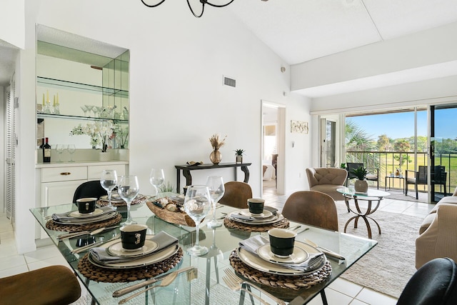 dining room with high vaulted ceiling, light tile patterned flooring, and visible vents