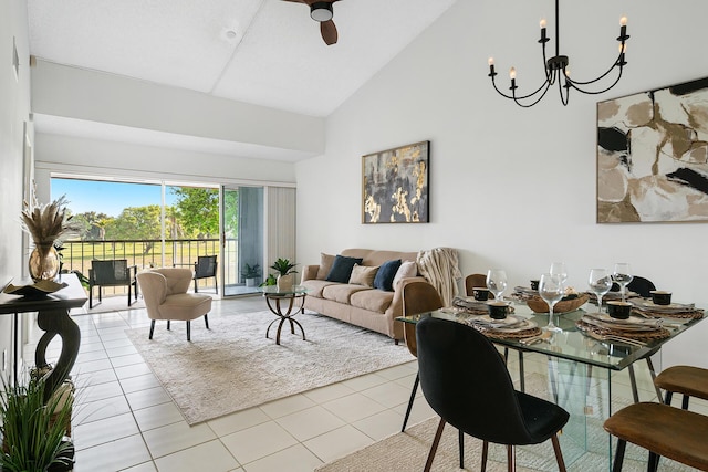 tiled living area with ceiling fan with notable chandelier and high vaulted ceiling