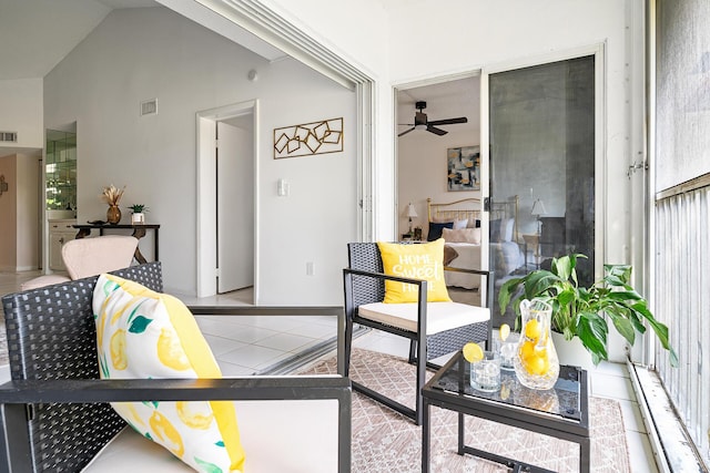 living room with lofted ceiling, ceiling fan, visible vents, and tile patterned floors