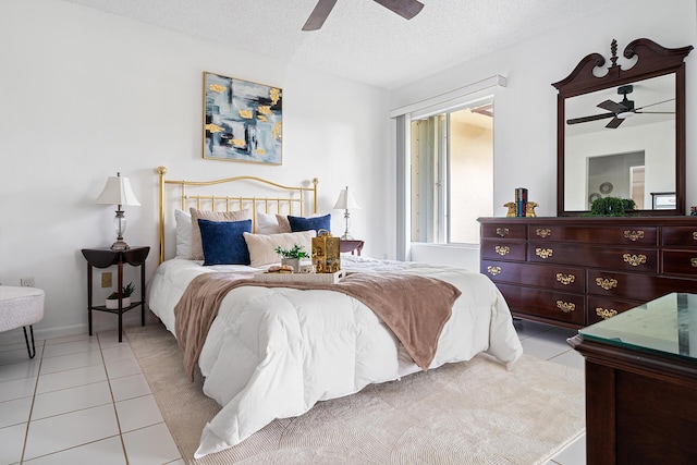 bedroom featuring a ceiling fan, a textured ceiling, and light tile patterned floors