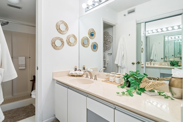 bathroom with visible vents, toilet, a shower stall, vanity, and tile patterned flooring