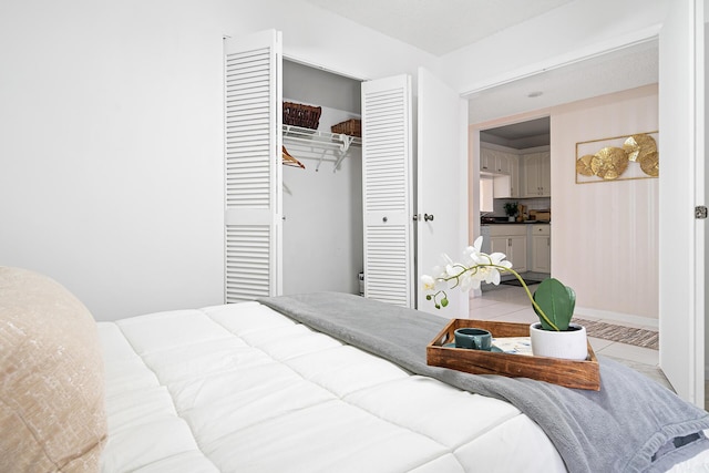 bedroom featuring a closet and light tile patterned flooring