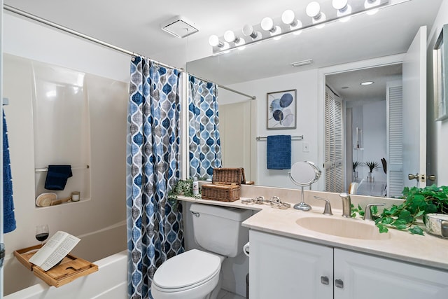 full bath with toilet, shower / bath combo with shower curtain, and vanity