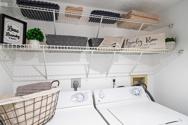 laundry area featuring laundry area, independent washer and dryer, and a textured ceiling