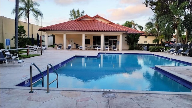 community pool featuring a patio area and fence