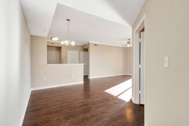 unfurnished room with visible vents, dark wood finished floors, baseboards, and ceiling fan with notable chandelier