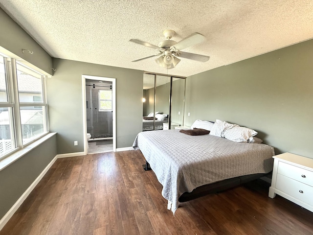 bedroom with a ceiling fan, wood finished floors, baseboards, ensuite bath, and a textured ceiling