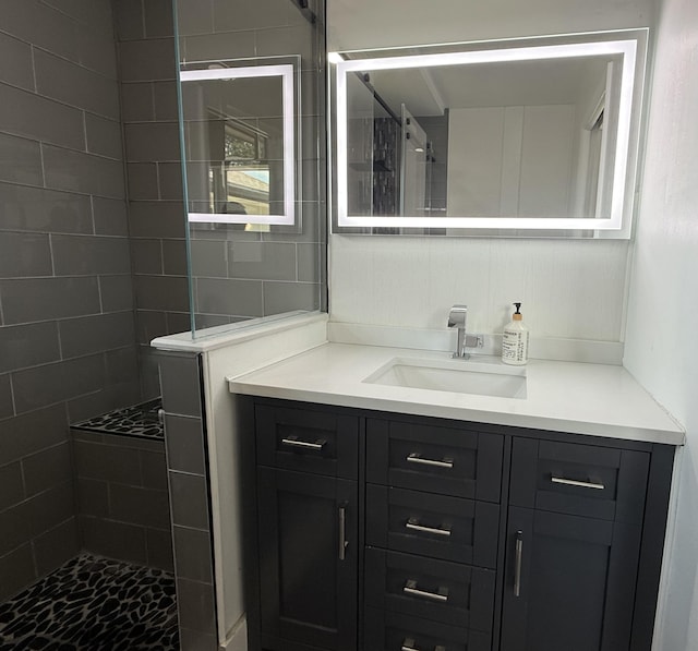 full bathroom featuring vanity and a walk in shower