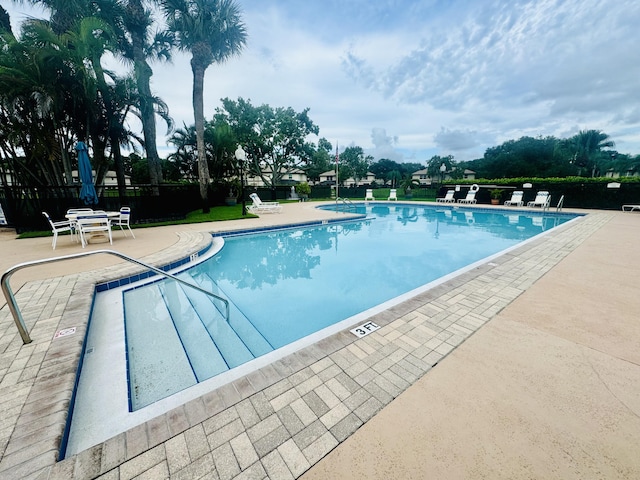 pool featuring a patio and fence