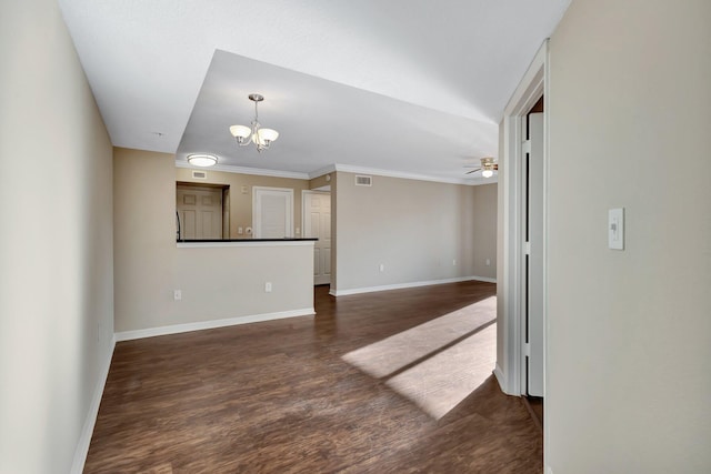 unfurnished living room with ceiling fan with notable chandelier, wood finished floors, visible vents, and baseboards