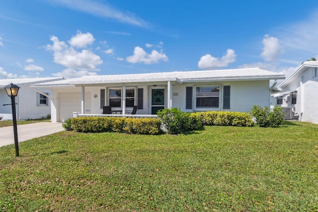 single story home with covered porch, a garage, concrete driveway, stucco siding, and a front yard