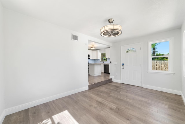 entrance foyer with visible vents, baseboards, and light wood-style flooring