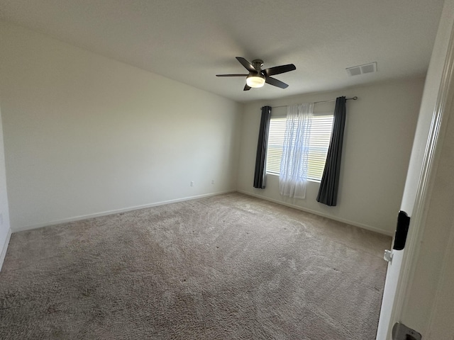 empty room with visible vents, ceiling fan, baseboards, and carpet floors