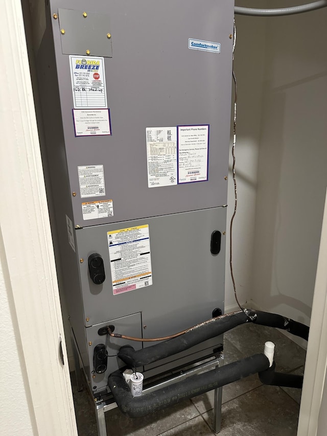 utility room featuring heating unit