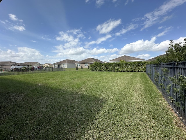 view of yard with a residential view and a fenced backyard
