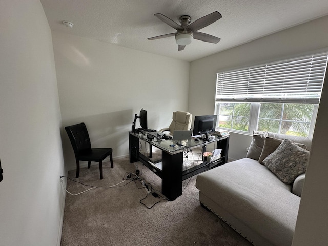 carpeted bedroom with a ceiling fan, a textured ceiling, and baseboards