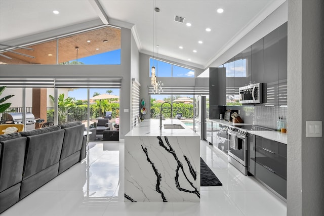 10786 Greenbriar Villa Dr, Lake Worth, FL 33449 - kitchen featuring light stone counters, a high ceiling, a healthy amount of sunlight, appliances with stainless steel finishes, and modern cabinets