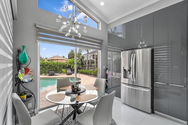 10786 Greenbriar Villa Dr, Lake Worth, FL 33449 - dining room featuring a chandelier, light tile patterned floors, crown molding, and a healthy amount of sunlight