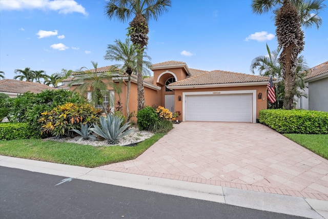 10786 Greenbriar Villa Dr, Lake Worth, FL 33449 - mediterranean / spanish-style home with a garage, a tiled roof, decorative driveway, and stucco siding