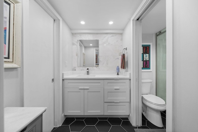 bathroom with tile patterned flooring, vanity, toilet, and recessed lighting