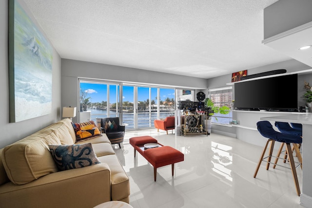 living room featuring plenty of natural light and a textured ceiling