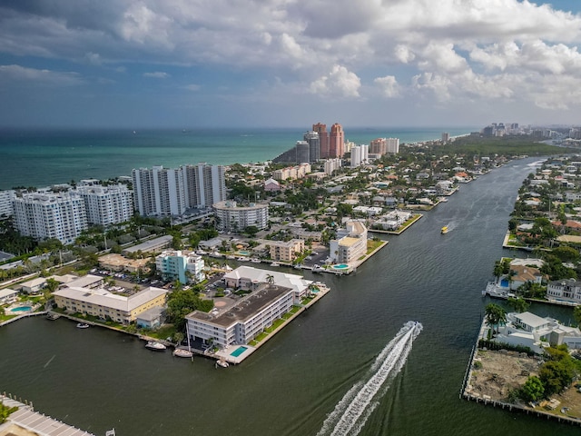 birds eye view of property with a water view and a city view