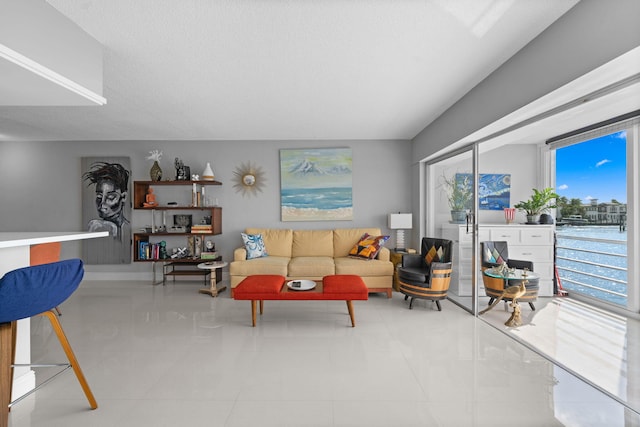 living area featuring a textured ceiling and tile patterned flooring