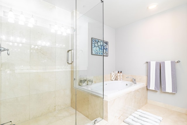 bathroom with tile patterned flooring, a shower stall, and a garden tub