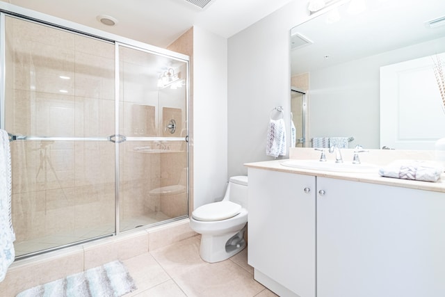 bathroom featuring vanity, tile patterned floors, toilet, and a stall shower