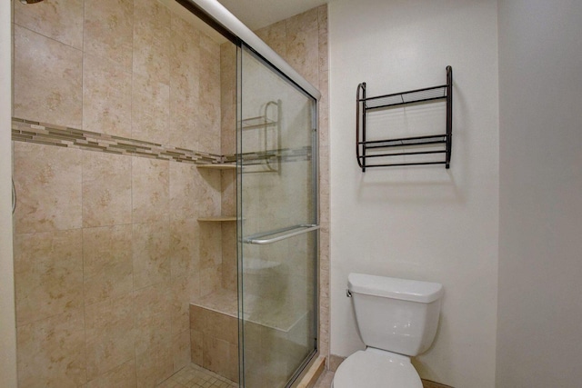 full bathroom with a stall shower and toilet