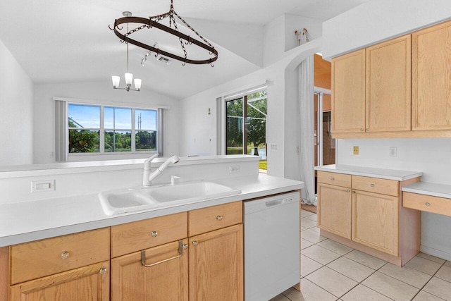 kitchen featuring plenty of natural light, white dishwasher, vaulted ceiling, and a sink