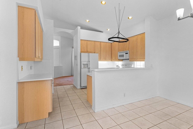 kitchen with white appliances, light countertops, a peninsula, and light tile patterned floors