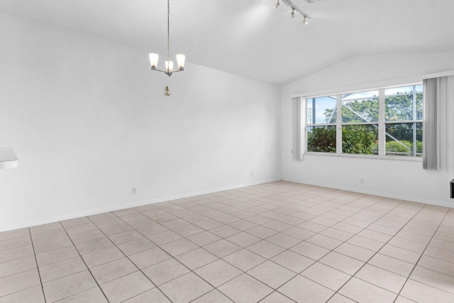 spare room featuring lofted ceiling, baseboards, a notable chandelier, and track lighting