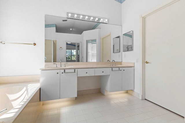 bathroom featuring double vanity, a stall shower, a garden tub, and a sink