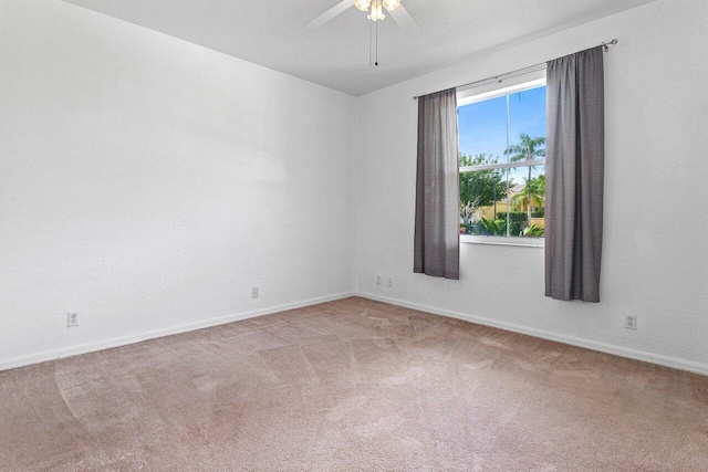 unfurnished room with baseboards, a ceiling fan, and carpet flooring