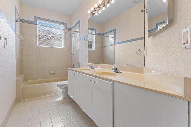 full bath with double vanity, toilet, tub / shower combination, a sink, and tile patterned flooring