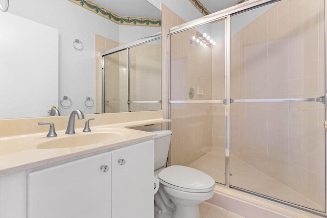 full bath with toilet, a stall shower, tile patterned flooring, and vanity