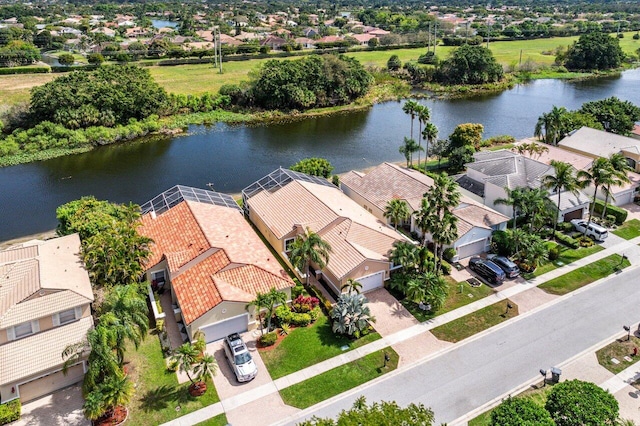 drone / aerial view with a residential view and a water view