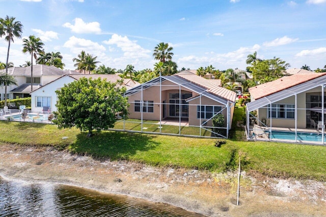 rear view of property with an outdoor pool, a lanai, a water view, and a yard