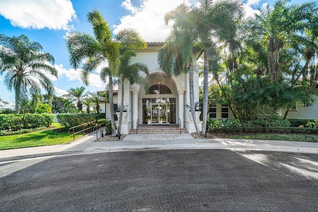 property entrance featuring french doors and stucco siding