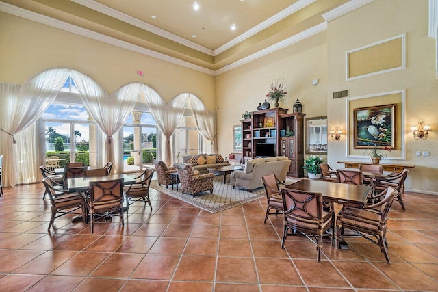 tiled dining space with visible vents, crown molding, and a towering ceiling