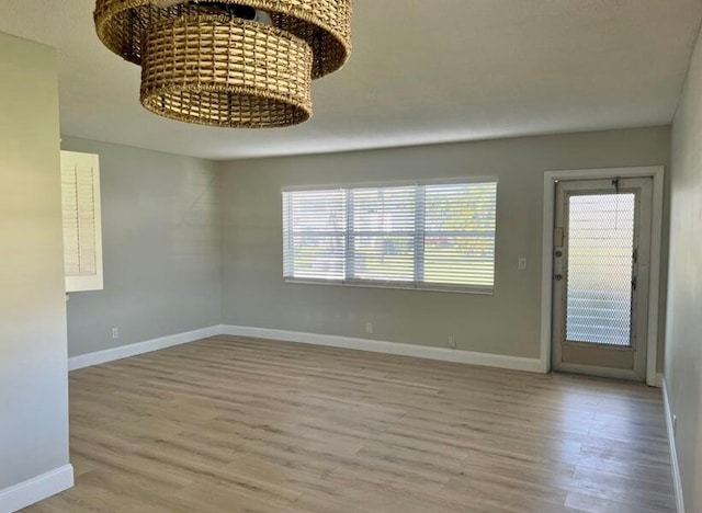 spare room featuring wood finished floors and baseboards