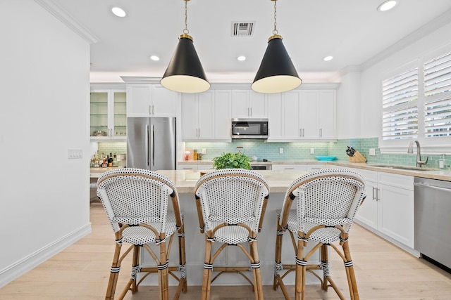 kitchen with visible vents, appliances with stainless steel finishes, and white cabinets