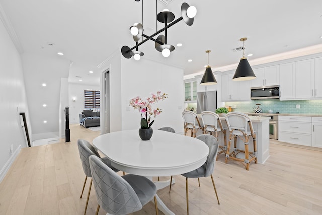 dining area featuring recessed lighting, visible vents, and light wood-style flooring