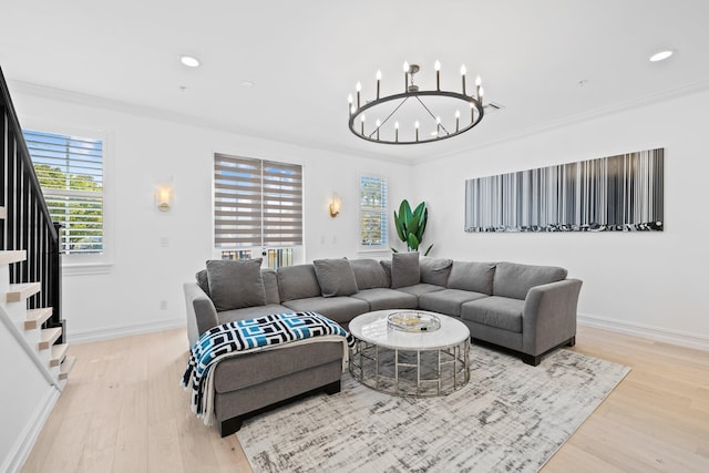 living area featuring light wood finished floors, baseboards, stairway, ornamental molding, and recessed lighting