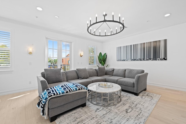 living room featuring crown molding, plenty of natural light, wood finished floors, and baseboards