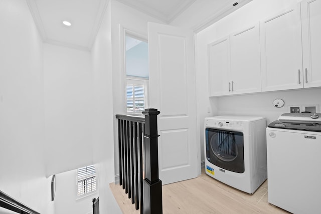 laundry area with cabinet space, ornamental molding, washing machine and clothes dryer, light wood-type flooring, and recessed lighting